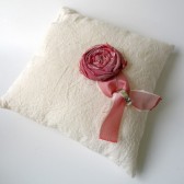 Cream muslin wedding ring pillow with red rosette