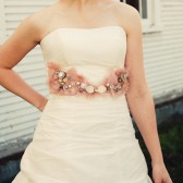 Blush pink feather sash with vintage buttons, pearls and brooches