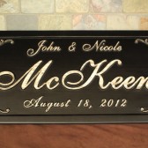 carved wooden established family name sign