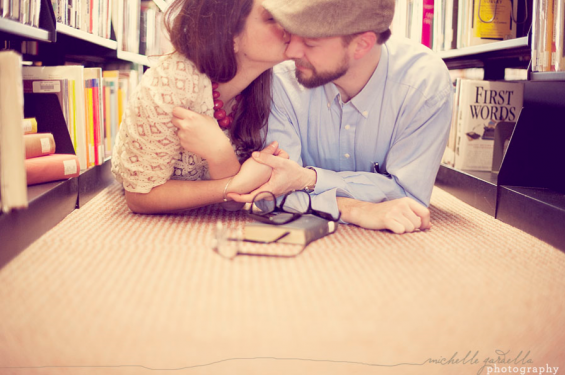 couple kissing in library engagement shoot library