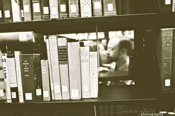 couple kissing behind books couple kissing behind books bw