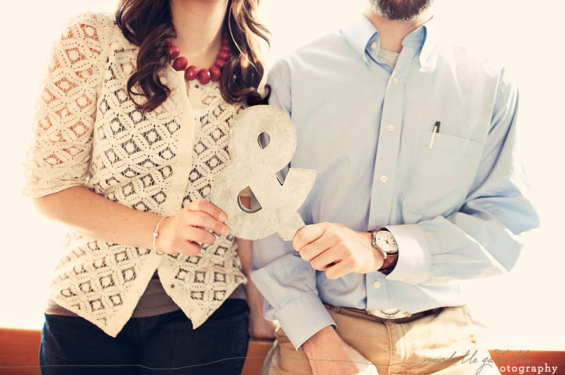 couple holding ampersand sign couple holding ampersand sign
