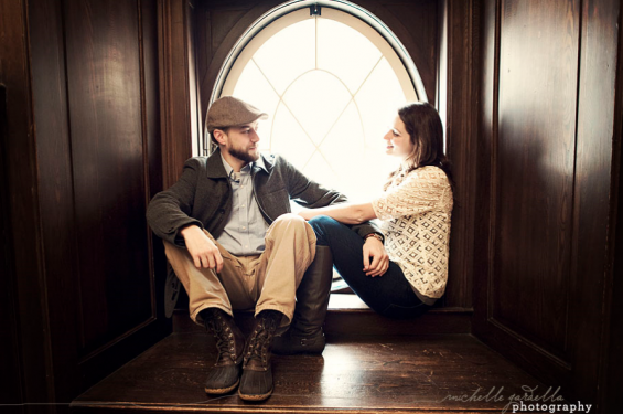 couple sitting in hallway school theme engagement session in hallway