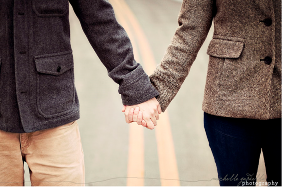 couple holding hands engagement shoot couple holding hands road