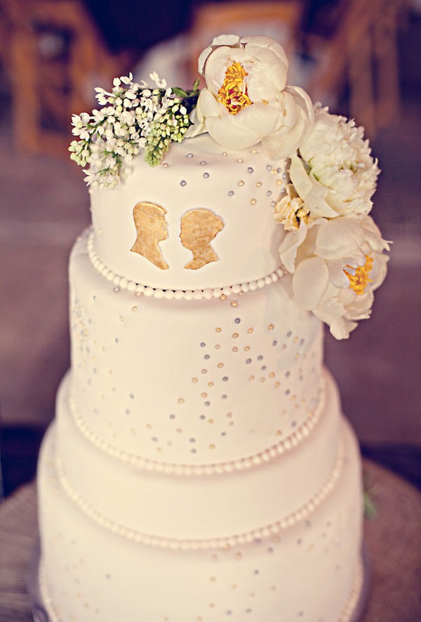 The wooden cake stand complements the rustic wedding theme used throughout 