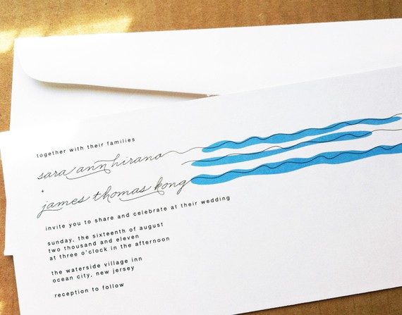 This wedding invitation features relaxing blue wave lines and fun typography