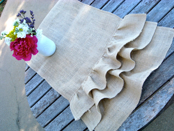 In this example a burlap table runner accentuates the center of the table