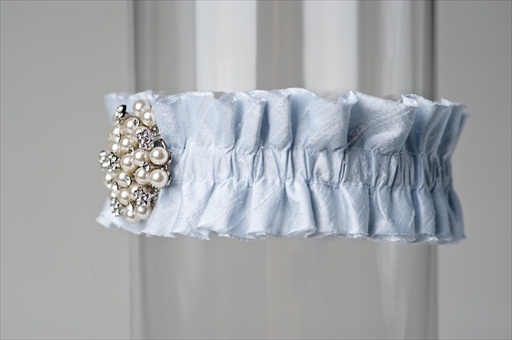 This wedding garter is made of light blue dupioni silk ribbon and features a