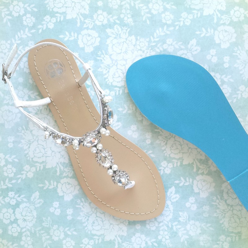 White white wedding sandals have a blue sole for an instant Something Blue. | via 31 Best Handmade Wedding Shoes https://emmalinebride.com/bride/handmade-wedding-shoes/